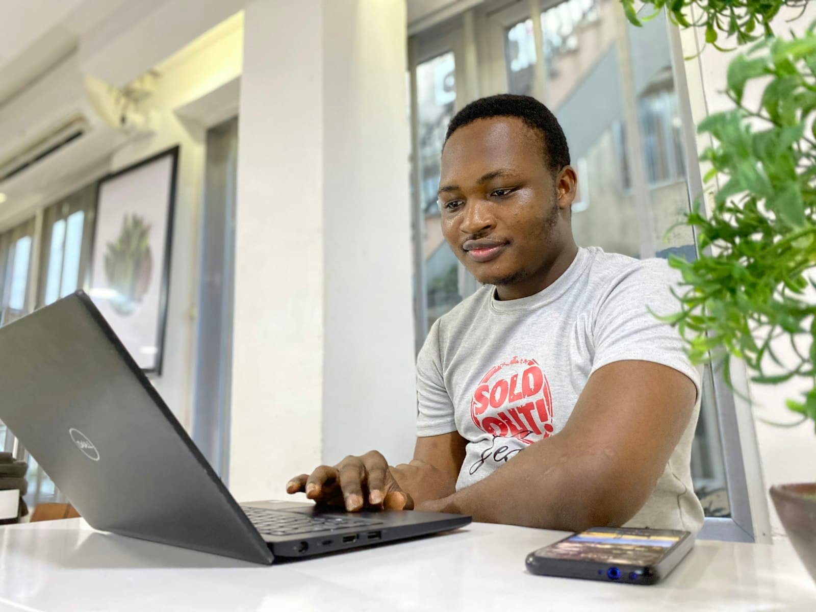 Customer service representative working at a desk, smiling while on a call