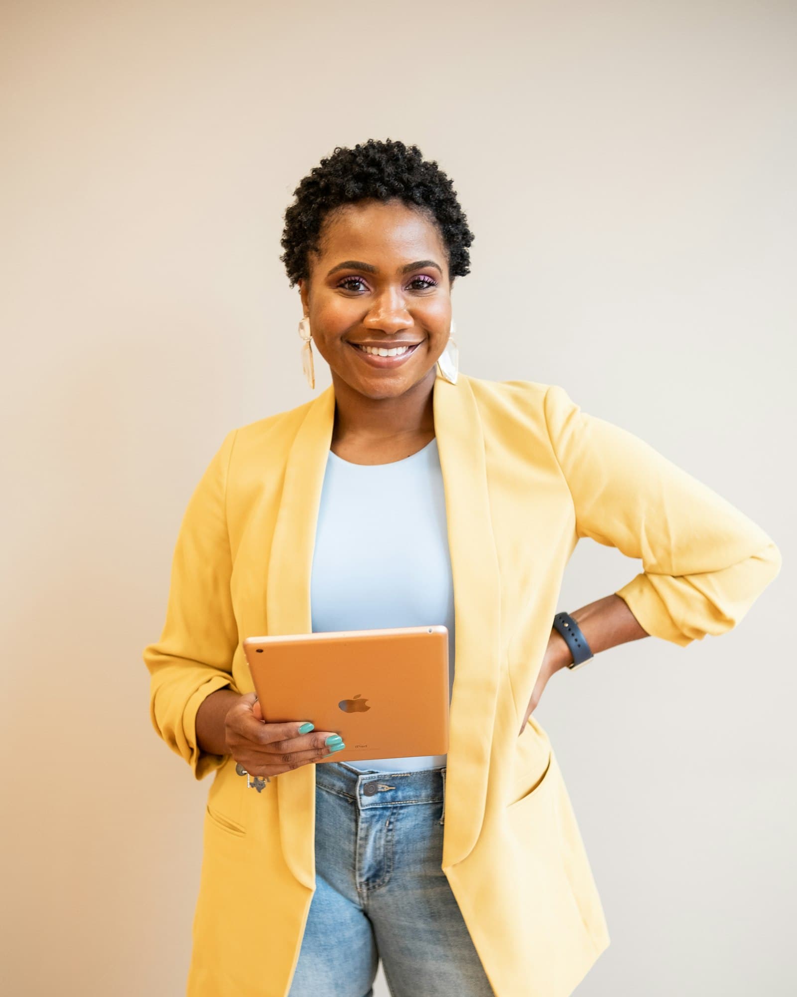 Trainer holding a tablet, presenting to a room
